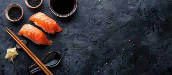 Authentic Japanese sushi displayed from above on a sleek black background complemented by soy sauce and chopsticks features salmon tuna and shrimp with copy space image