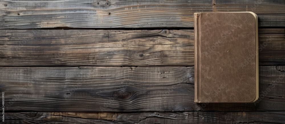Poster wooden textured surface with a blank notebook creating a copy space image