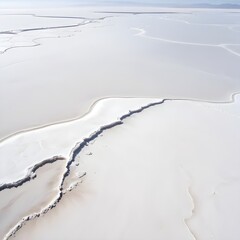 Obraz premium Aerial photograph of a vast salt flat or salt desert with a clean, bright white backdrop
