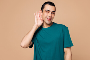 Young curious nosy middle eastern man wear blue t-shirt casual clothes try to hear you overhear...