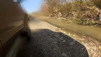 footage of 4 by 4 jeep crossing through the water in the river 