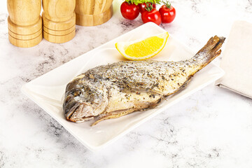 Baked Dorado fish served lemon