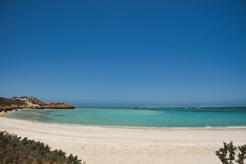 Shallow sea with pleasure craft and a sandy coast at Coral Bay, Ningaloo Coast, Western Australia
