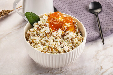 Curd with granola and orange jam