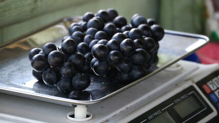 black grapes being weighed