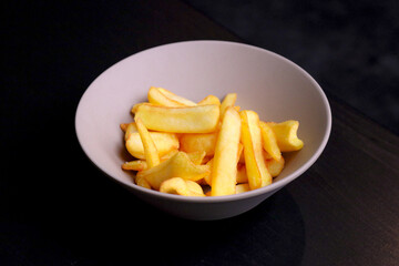 Table scene of assorted take out or delivery foods. Hamburgers, pizza, fried chicken and sides. Top down view on a dark wood banner background.