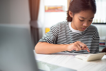 Little girl doing math task in classroom