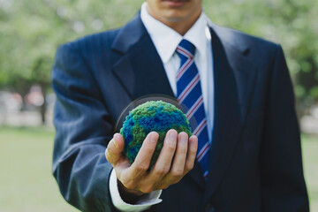 Businessmen holding the green ball whit ESG, net zero, eco, co2, carbon, human hand holding green...