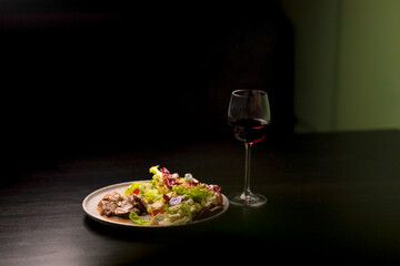 Table scene of assorted take out or delivery foods. Hamburgers, pizza, fried chicken and sides. Top down view on a dark wood banner background.