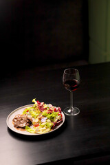 Table scene of assorted take out or delivery foods. Hamburgers, pizza, fried chicken and sides. Top down view on a dark wood banner background.