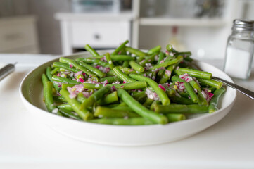 Fresh prepared green bean salad with onions and vinegar, oil dressing