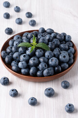 Fresh blueberries on a wooden white table, with copy space for text