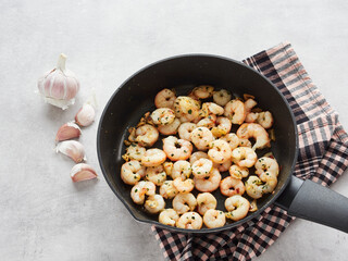 pan fried prawns with garlic, on the countertop fresh garlic head
