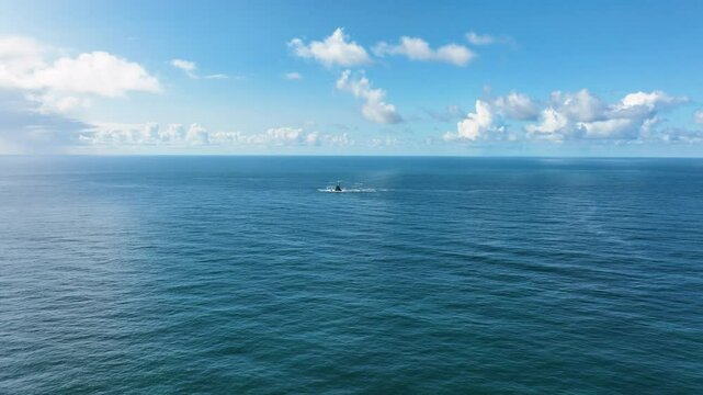 A lighthouse rising out of the ocean. Fastnet lighthouse from drone