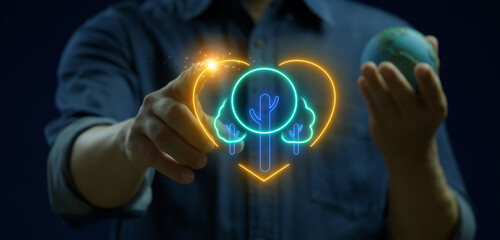 Ecological, ESG, renewable green energy and save the world sustainable. Sharing, reusing and environmental care. Businessman holding earth model to show tree inside heart shape icon.