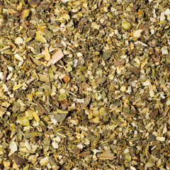 Herb blend seasoning of oregano, basil, onion, garlic and thyme, macro, top view.