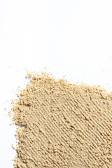 Ground dry ginger root on a white background, place for text