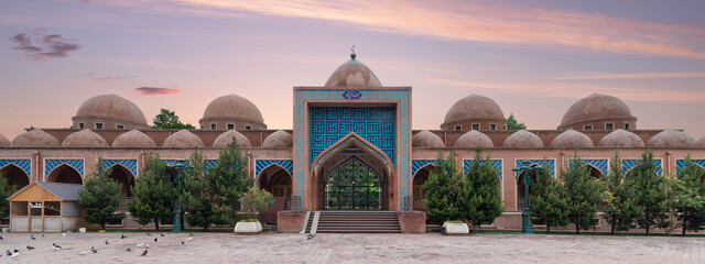 The Imamzadeh Mosque in Ganja, Azerbaijan, features a large courtyard with a central entranceway....