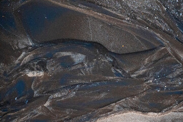 Natural texture: top view of beach sand, clear, clean and smooth. Minimalist background for summer concepts, travel, vacations and outdoor enjoyment.