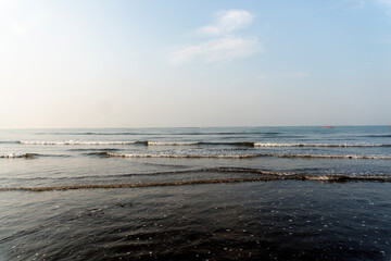 clouds in blue sky over sea and reflections of sun