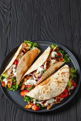 grilled chicken street tacos on a dark plate