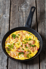 deli ham onion omelette on skillet, top view