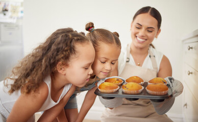 Children, smell and food with mother in kitchen for baking muffins, delicious aroma and hungry for sweet breakfast. Woman, kids and dessert tray with bonding, teaching and love cooking at house