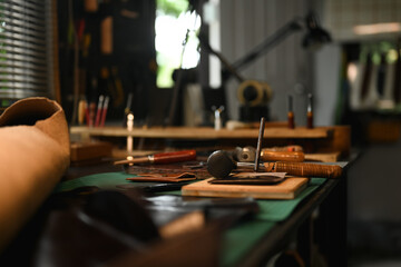 Leather craft work tools on the workbench. Small business and handmade concept