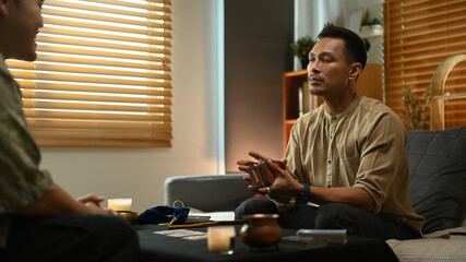 Fortune teller holding tarot cards predicting the future for client. Forecasting and divination...