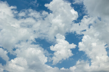 White fluffy clouds on the blue sky. Sky with clouds background.