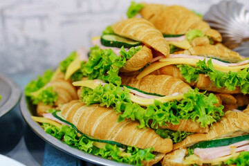 croissants with ham, cheese and lettuce. 