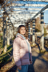 Winter Fun in Bitigheim-Bissingen: Beautiful Girl in Pink Jacket Amidst Half-Timbered Charm. a lovely girl in a pink winter jacket standing in the archway of the historic town