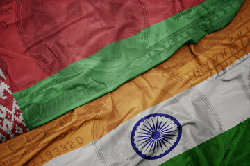 waving colorful flag of india and national flag of belarus on the dollar money background. finance concept.