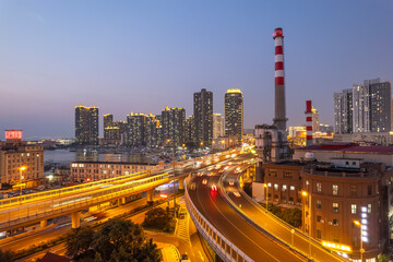 Fototapeta premium Vibrant Urban Cityscape with Illuminated Highways and Skyscrapers