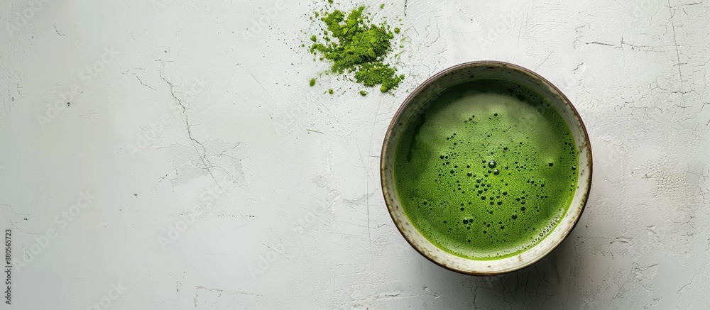 Aufkleber Bird s eye view of a cup filled with matcha green tea on a blank white surface with space for text or other elements creating a copy space image