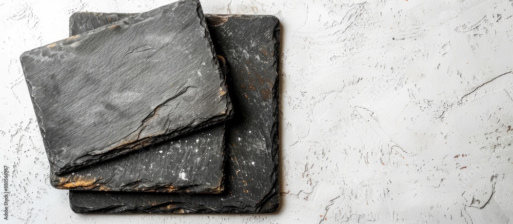 Poster Top view of slate cooking boards on a white surface with space for text ideal for a copy space image mockup