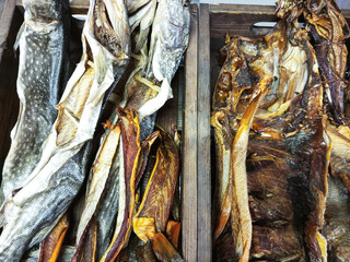 Dried stockfish in wooden boxes close-up. View from above.