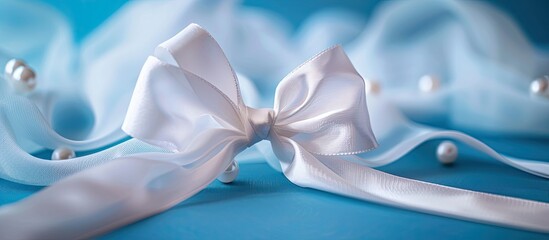 Lung Cancer Awareness symbol alongside Mesothelioma and Retinoblastoma signs shown A white pearl ribbon bow curls on a blue backdrop with a copy space image symbolizing purity and support against viol