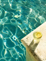 Top View of a light green Drink by the Poolside. Luxury Vacation Wallpaper