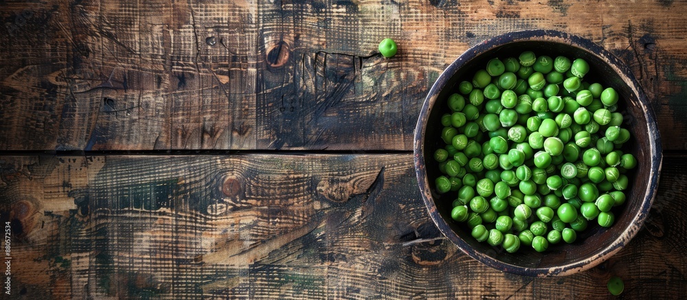 Poster Peas in a bowl on a wooden surface with a blank space for an image. copy space available