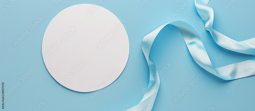 Aufkleber An overhead perspective of a vacant white circle adorned with a soft blue ribbon on a bright isolated backdrop perfect for adding text or images. copy space available