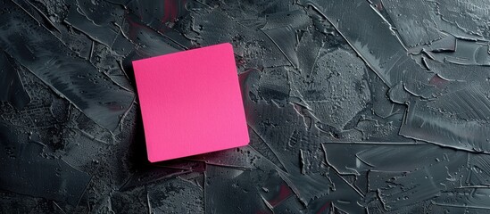 Copy space image with a pink note set against a black gradient backdrop