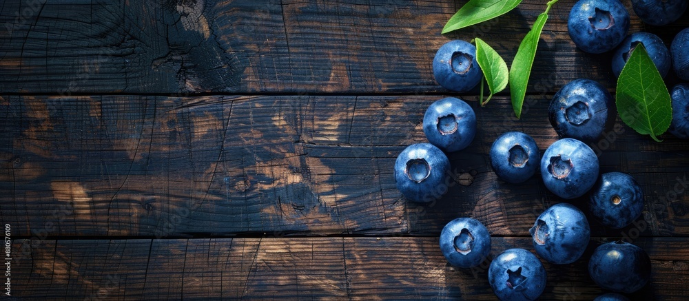 Poster Top view high resolution image with blueberries on a wooden surface conveying a concept related to harvesting with space for duplication. copy space available