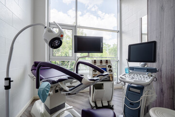 Gynecologist's chair and ultrasound machine in a gynecologist clinic