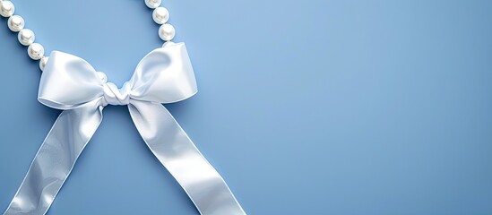 Lung Cancer Awareness symbol alongside Mesothelioma and Retinoblastoma signs shown A white pearl ribbon bow curls on a blue backdrop with a copy space image symbolizing purity and support against viol