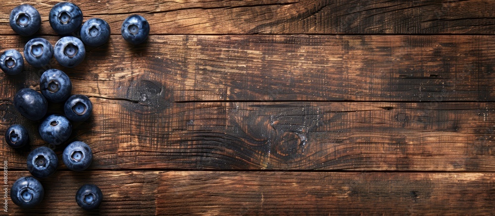 Poster Top view high resolution image with blueberries on a wooden surface conveying a concept related to harvesting with space for duplication. copy space available
