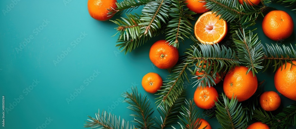 Aufkleber christmas tree branches with tangerines arranged on a bright backdrop creating a beautiful copy spac