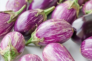 Close up of striped eggplants on white surface