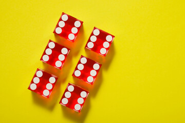Close-up of a red dices on a yellow table