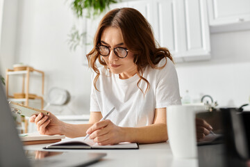 Middle-aged woman sitting at desk, engrossed in writing on notebook.